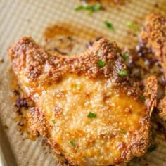 some fried food sitting on top of a piece of paper with green garnish