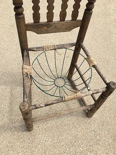 an old wooden chair sitting on the ground