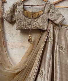 Features a vintage gold raw silk lehenga hand embellished with sequins, pearl and cutdana buttis and a zari and pearl work border. Paired with a matching raw silk blouse hand embroidered with zardozi, sequin and pearl work and a matching sequinned net dupatta Composition : Lehenga and Blouse - Raw Silk, Dupatta - Soft Net All products can be customised for sleeves, length of blouse and neck design Delivery : 2-4 weeks as the product is hand crafted. Check Size Guide or choose MySize for free customisation (All Sizes above XL can be made at 15% additional cost) For more information and sizes please contact fabiliciousfashion@gmail.com or visit our Copenhagen studio.About the Designer : Priti Sahni started out with a career on the well-trodden path by following typical Indian parent’s goal, Raw Silk Blouse, Raw Silk Lehenga, Zardosi Work, Tan Blouse, Pearl Work, Travel Infographic, Lehenga Designs Simple, Bridal Lehenga Collection, Brown Blouse