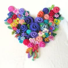 a bunch of colorful felt flowers on a white background with the words crochet pattern below it