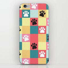 an iphone case with colorful squares and paw prints on the front, in various colors