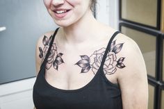 a woman with tattoos on her chest smiling