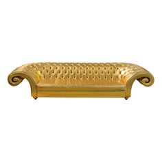 a gold colored couch sitting on top of a white floor