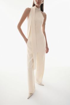 Introducing the luxurious jumpsuit. This sleek and sophisticated jumpsuit features a halter neckline and sleeveless design, perfect for any special occasion. Made from high-quality crepe fabric, it flows elegantly down to the floor for a stunning look. Length:- Front length: 150cm/152cm/154cm (S/M/L)- Back length: 117cm/119cm/121cm (S/M/L) Elegant Strapless Halter Neck Jumpsuit For Spring, Elegant Halter Neck Strapless Jumpsuit For Spring, Elegant Fitted Halter Neck Strapless Jumpsuit, Elegant Halter Neck Evening Jumpsuits And Rompers, Elegant Halter Neck Jumpsuits And Rompers For Formal Occasions, Elegant Formal Halter Neck Jumpsuits And Rompers, Elegant Formal Halter Neck Jumpsuits, Chic Summer Jumpsuits And Rompers For Gala, Summer Formal Strapless Halter Neck Jumpsuit