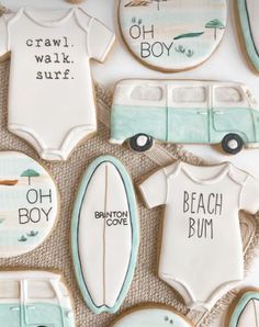 decorated cookies are arranged in the shape of surfboards and cars with words on them