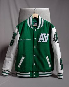 A Anniversary Varsity Green Double Letterman Jacket Customized Material: Leather Internal: Premium Soft Lining Collar: Rib-Knitted Collar Closure: Zipper Closure Color: Red #VarsityJacket #GreenVarsity #AnniversaryJacket #RetroFashion #StreetwearStyle #LettermanJacket #UrbanFashion #LuxuryStreetwear #SportyChic #VintageVibes #VarsityFashion #StreetwearCulture #RetroChic #FashionTrends Jacket Customized, Stitch Lines, Standing Collar, Letterman Jacket, Brand Story, Sporty Chic, Retro Chic, Diamond Pattern, Luxury Streetwear