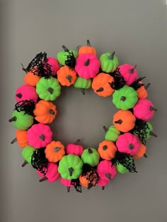 a wreath made out of fake pumpkins and black netting