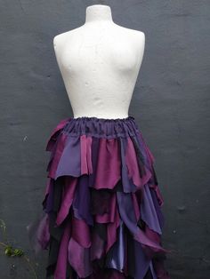 a mannequin wearing a purple and black skirt with ruffles on it