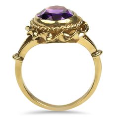 A 9k yellow gold amethyst ring. The ring features a center oval shape amethyst, measuring 9 x 7 mm, estimated at 1.7 carats. The amethyst is bezel set with two outer rims, one with milgrain detail and one with a wavy pattern around the top of the ring and an open shoulder design. Stamped "9 375". Finger size 3.75 Replacement Value: $450 Classic Amethyst Oval Cabochon Ring, Classic Oval Amethyst Ring, Oval Amethyst Heirloom Ring With Bezel Setting, Oval Bezel Set Amethyst Heirloom Ring, Classic Oval Purple Amethyst Ring, Heirloom Style Purple Oval Amethyst Ring, Heirloom Oval Purple Birthstone Ring, Heirloom Purple Oval Birthstone Ring, Classic Oval Purple Birthstone Ring