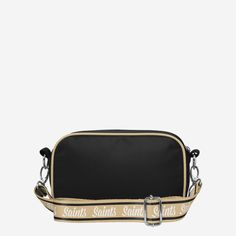 a black and beige bag with the words saint laurent on it