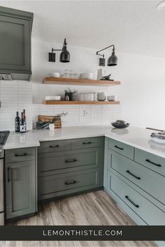 a kitchen with gray cabinets and white counter tops, wood flooring and open shelving