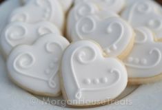 some heart shaped cookies on a white plate