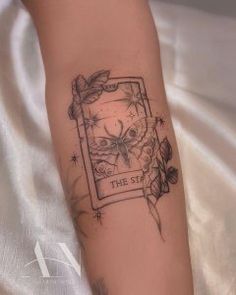 a woman's arm with a tattoo on it that reads, the star and leaves