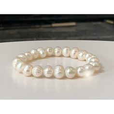 "This classically beautiful and elegant natural freshwater pearl bracelet features natural (Cultured) white freshwater pearls all strung together on high-quality elastic stretch cord. Pearl beads range in 7mm-8mm size.   Freshwater pearls are very versatile and give a polished look to any style of design. Enjoy this perfect addition to your wardrobe.    BRACELET SIZE INSTRUCTIONS  See 2nd Item Photo for a Pictorial Instruction. We make all our bracelets to actual \"wrist size\" (not \"bracelet size\" or \"bracelet length\") Select your actual Wrist Size (in inches) from the dropdown menu.    Simply measure around your wrist in inches at the location where you want to wear the bracelet.     **How to Measure Your Wrist for Proper Bracelet Size**     Wrap a flexible measuring tape around the Pearl White Bracelets With 8mm Pearl Beads, White Pearl Stretch Bracelet With Pearl Charm, Elegant White Stretch Bracelet With 8mm Beads, Classic White Pearl Stretch Bracelet, White Spiritual Bracelets With Pearl Charm, Spiritual White Bracelets With Pearl Charm, White Pearl Bracelets With Spiritual Style, Pearl White Pearl Bracelet With 8mm Beads, Classic Pearl Stretch Bracelet For Gifts