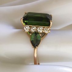 Free express shipping and customs fees to the United States Discover the allure of our Certified Green Tourmaline Ring with Brilliant Diamonds in Stylish 14K Gold. Handcrafted as a unique statement piece, it's the perfect gift for a girlfriend, mother, or sister. Ideal as a graduation present, elevate her style with this exquisite gemstone ring today Technical details: -American Size:7.25 E-u  15, Inner Diameter 17.5 GEMSTONE: Main Gemstone: One untreated natural green emerald-cut rectangular to Classic Green Tourmaline Jewelry, Green Tourmaline Wedding Rings, Classic Tourmaline Jewelry For May Birthstone, Formal Tourmaline Rings For May Birthstone, Classic Tourmaline Wedding Jewelry, Elegant Tourmaline Jewelry For May Birthstone, Elegant Pear-shaped Tourmaline Jewelry, Statement Rings Unique, Graduation Present