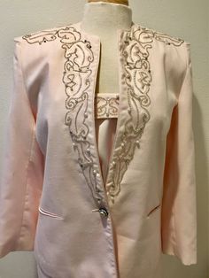 "Light Pink Beaded Detail 3 piece Special Occasion Designer Suit by Della Roufogali ladies size 8 D*E*S*C*R*I*P*T*I*O*N Jacket; Gorgeous 3 piece suit has a lot to love. Jacket has stunning silver, beads, pearls and rhinestones, exclusive of decoration on shoulders, upper back, and going down front sides. More features are; Stunning single & large rhinestone with pearl button for closure, with smaller but matching buttons at end of arms sleeves... Fully lined, fabric content is 65% Polyester Elegant Fitted Embellished Set, Spring Embellished Fitted Sets, Fitted Evening Sets With Rhinestones, Elegant Party Sets With Rhinestones, Elegant Rhinestone Sets For Parties, Elegant Fitted Set With Rhinestones, Elegant Fitted Sets With Rhinestones, Elegant Beaded Festive Sets, Elegant Beaded Sets For Festive Occasions