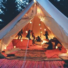 a group of people standing inside of a tent