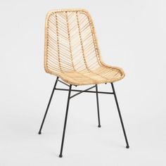 a wicker chair with black metal legs