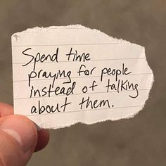 someone holding up a piece of paper that says, spend the praying for people instead of talking about them