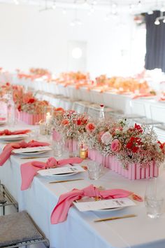 the tables are set with pink napkins and place settings for guests to sit at