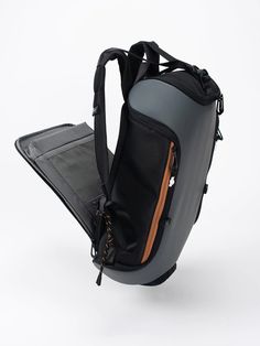 the back view of a backpack with its zipper open and straps hanging down, on a white background