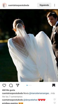 a woman in a wedding dress with a veil on her head is standing next to a man wearing a tuxedo