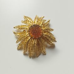 Sarah Coventry Sun Flower Ladies Brooch Vintage 1960s Woman's Costume Jewelry. Measurements: Diameter 4.6 cm / 1.8 inches Designer: In 1949 Charles H. Stuart began a jewellery company which he named after his granddaughter Sarah Coventry. He began selling through home parties which lasted until 1984 when the company was sold. Sarah Coventry jewellery was not designed or manufactured in-house, it was made by other companies in Rhode Island. Sarah Coventry gold tone sunflower brooch featuring an amber glass centre and textured petals. This is a a beautiful vintage brooch by American company Sarah Coventry dating to the 1960s. Please read before making purchase. Shipping fees differ from my standard rates when having the item shipped to the following locations: Isle of Man, the Channel Island Sarah Coventry Jewelry, Sarah Coventry, Vintage Art Glass, Vintage Fishing, Vintage Avon, Coventry, Flower Pins, Women's Costumes, Jewelry Companies