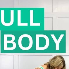 a woman sitting at a table in front of a green sign that says full body