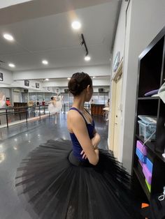 a woman sitting on the floor in a dance studio