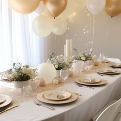 a table set with plates, silverware and balloons