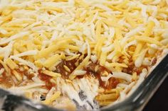 a casserole dish filled with cheese and sauce