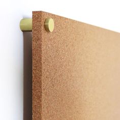 a close up view of a cork board with two holes in the middle and one hole at the bottom