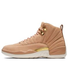 The Women's Air Jordan 12 Retro 'Vachetta Tan' is a beautiful update to the classic Air Jordan 12. The luxurious suede upper and quilted interior give the shoe an elevated look, while still maintaining the same great fit and feel of the original. The embossed leather heel tab and brushed gold hardware add a touch of sophistication, making this sneaker perfect for any occasion. (SNKR/Women's) Nike Air Max 87, Tan Sneakers, Jordan Retro 12, Mens Basketball Shoes, Jordan Model, Air Jordan 12, Shoe Gallery, Womens Air Jordans, Air Jordan 12 Retro