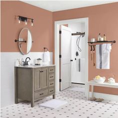 a bathroom with pink walls and white tile on the floor is pictured in this image