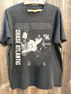 Retro Chase Atlantic Music Band Shirt, Chase Atlantic Concert Tour 2024, Chase Atlantic Unisex Tshirt, Gift For Men Women All t-shirts are custom made to order and are printed using the latest ink to garment technology, a technology superior to heat transfer or screen print. - Heather colors are 52% combed and ring-spun cotton, 48% polyester - Athletic and Black Heather are 90% combed and ring-spun cotton, 10% polyester - Solid Colors 100% pre-shrunk cotton - Fiber content may vary by color FOR THE BEST FIT; (See Size Chart in Images). 1) Lay a t-shirt on a flat surface. 2) Measure the chest area, just under the armpit from side to side find the shirt's width. 3) Then measure the length from top of the shoulder to the bottom of the shirt to find the shirt's length. 4) After taking your mea Chase Atlantic Clothes, Chase Atlantic Shirt, Consume Chase Atlantic, Christian Anothny Chase Atlantic, Dont Chase Men Chase Atlantic, Band Shirt, Band Shirts, Unisex Tshirt, Men And Women