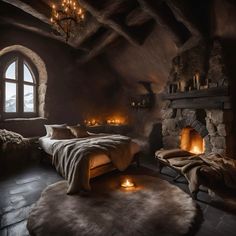 a bedroom with stone walls and flooring has a fireplace in the corner that is lit by candles