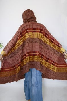 Keep warm in this thick sweater shawl. It’s wide, plaid pattern makes it a modern yet classic addition to your style arsenal. The hood makes it magical. One Size Fits All Cozy Plaid Sweater, Cozy Brown Shawl For Fall, One-size Brown Sweater Coat For Winter, One Size Brown Sweater Coat For Winter, Brown One-size Sweater Coat For Winter, Cozy Winter Poncho For Cold Weather, Cozy Brown Hooded Poncho, Cozy Wool Poncho For Fall, Oversized Plaid Sweater For Winter