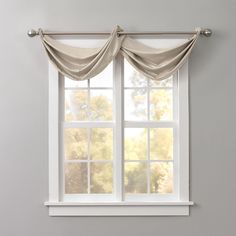 an open window with curtains hanging in front of it