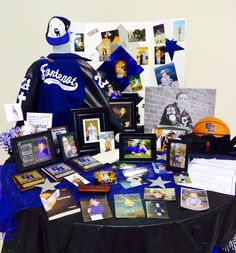 a table topped with pictures and photos next to a basketball helmet on top of a table