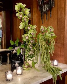 candles and flowers on a marble counter top