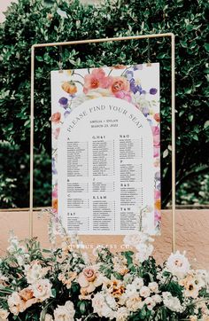 a seating chart with flowers and greenery on it