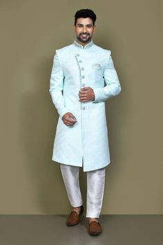 Firozi green full sleeves asymmetric hem and placket sherwani crafted in imported jacquard silk with all over blossom pattern and hand embroidery on the band collar neckline and buttons. Paired with an off white dupion art silk Aligadhi pant. - Aza Fashions Green Sherwani, Self Design, Band Collar, Full Sleeves, Pocket Square, Asymmetric Hem, Aza Fashion, Full Sleeve, Hand Embroidery