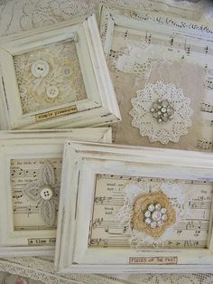 three framed pictures with buttons and lace on them sitting on top of sheet music sheets