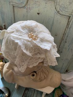 "Beautiful hat of antic lace. With a corsage, also from old lace with pearls. It is a nice , easy wearing model. Middle size Hand made Silk inside Still in perfect condition From France Also nice hanging on an old \"regale\"" Elegant Lace Bonnet With Lace Trim, Vintage Cloche Fascinator For Wedding, Fitted Vintage Bonnet With Lace Trim, Vintage Cloche Wedding Headpiece, Vintage Wedding Cloche Headpiece, Adjustable Lace Wedding Bonnet, Wedding Bonnet With Lace Trim, Victorian Cloche Hat For Weddings, Vintage Cloche Hat For Wedding