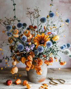 a vase filled with lots of different types of flowers