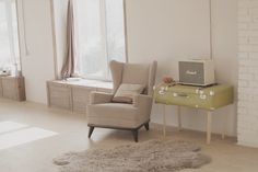 a living room filled with furniture and a yellow table in front of a large window