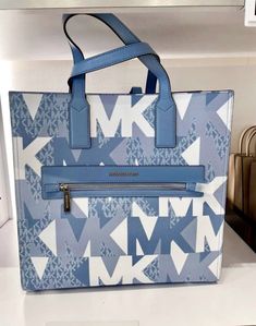 Michael Kors Kenly Large NS Tote Crossbody Graphic Logo MK Blue White Multi. Michael Kors Kenly Large NS Tote Kenly Large Graphic Logo Tote Bag your daily tote bag. Made from coated canvas with a graphic take on our logo initials, this structured carryall features sleek top handles and a front zip pocket that will keep your essentials within arm’s reach • Tote bag • Logo-print canvas • Silver-tone hardware • 14.25”W X 14”H X 5.5”D • Adjustable strap: 16”-25” • Exterior details: front zip pocket • Interior details: back zip pocket, 2 back slip pockets Price is firm Luxury Multicolor Formal Leather Shoes, Luxury Workwear Boots, Luxury Blue Formal Boots, Luxury Boots For Workwear, Blue Large Capacity Coated Canvas Bag, Large Capacity Blue Coated Canvas Bag, Blue Double Handle Shoulder Bag With Logo, Blue Shoulder Bag With Logo And Double Handles, Blue Coated Canvas Bags For Errands