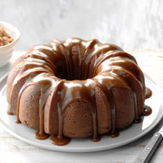 a bundt cake on a white plate with caramel drizzle