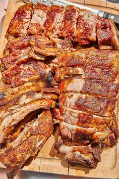 sliced meat sitting on top of a wooden cutting board