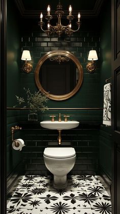 a bathroom with green walls, black and white tile flooring and a gold framed mirror above the toilet